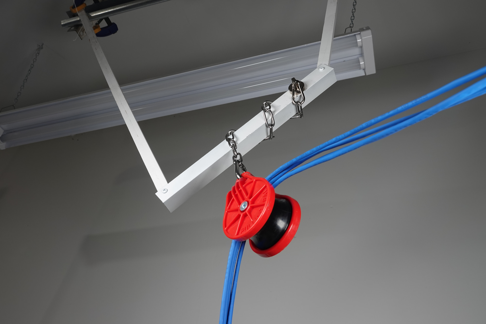 PP10 hung by its chain, guiding a cable bundle through a direction change